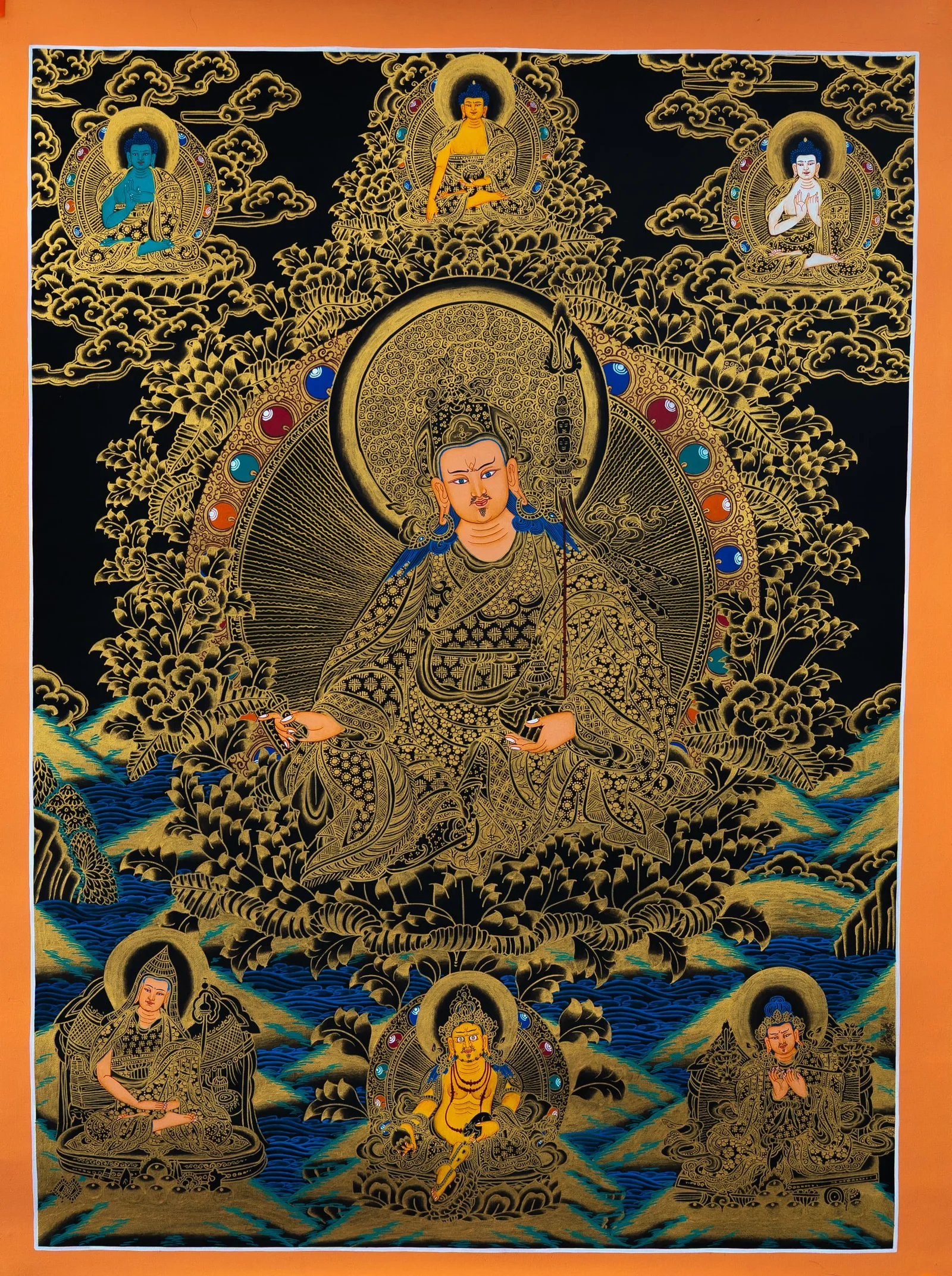 Guru Rinpoche seated in a lotus hat holding a vajra and skull cup, black and gold thangka with Buddhas above and attendants below
